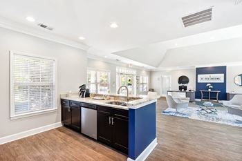 a kitchen with a blue counter top and a living room